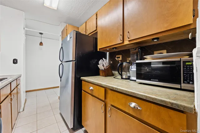 a kitchen with stainless steel appliances a refrigerator and a stove top oven