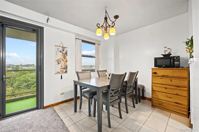 a view of a dining room with furniture and a window