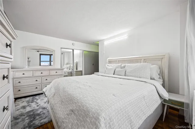 a bedroom with a bed and a dresser