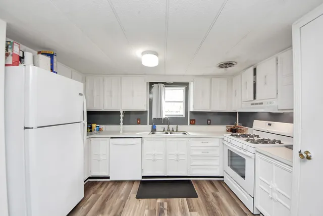 a kitchen with a refrigerator and a stove top oven