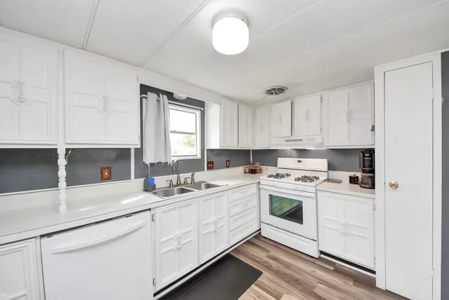 a kitchen with a white cabinets and white appliances