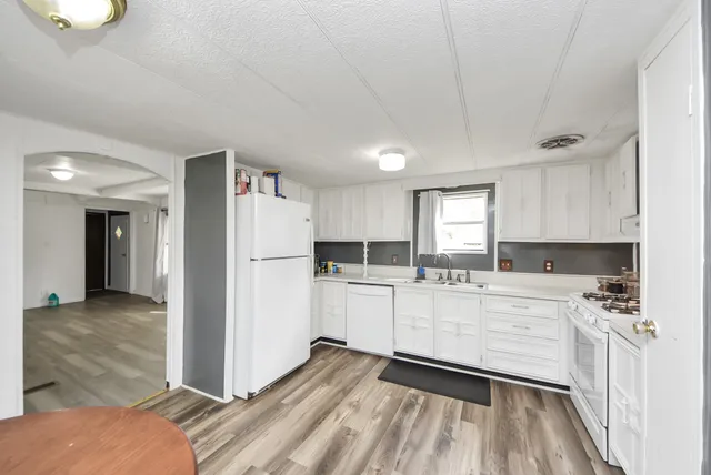 a kitchen with a refrigerator and a stove top oven
