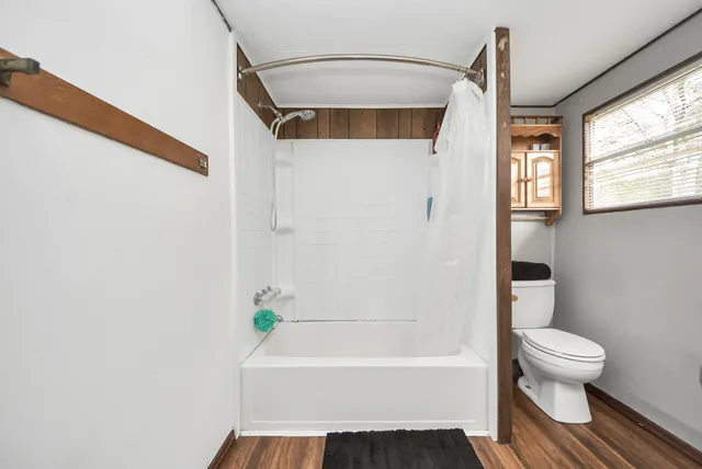 a bathroom with a toilet and a bathtub