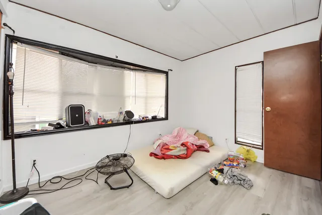 a bedroom with furniture and a window