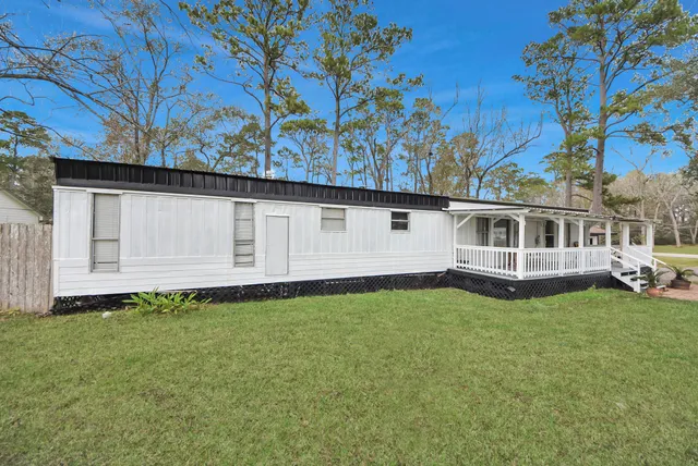 a view of house with backyard