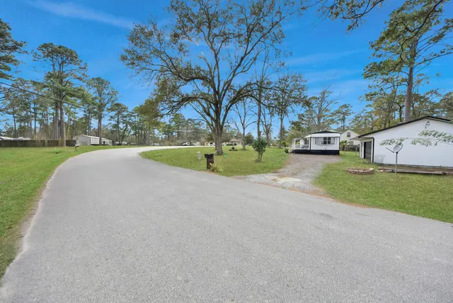 a view of a backyard with swimming pool