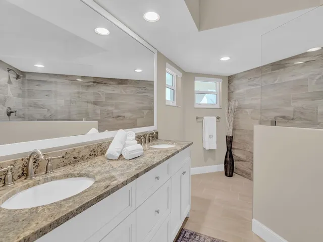 a bathroom with a granite countertop sink mirror and double