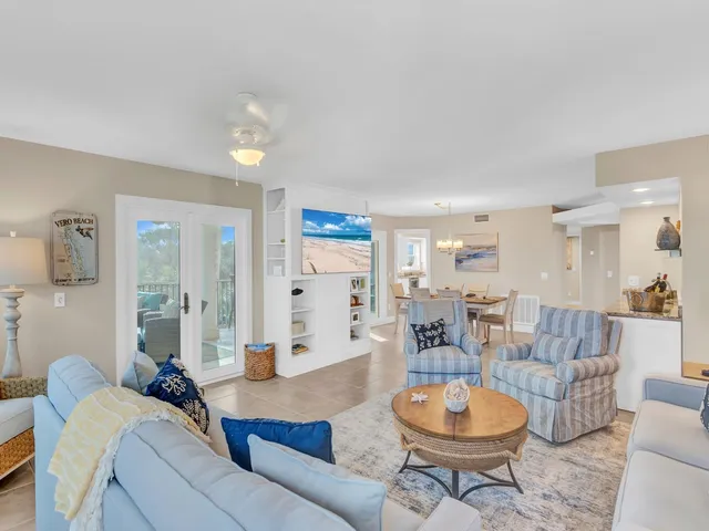 a living room with furniture a window and kitchen