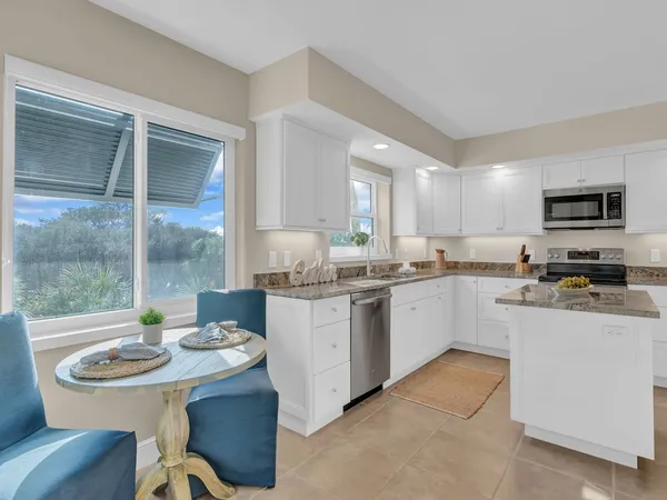 a kitchen with stainless steel appliances kitchen island granite countertop a sink and cabinets