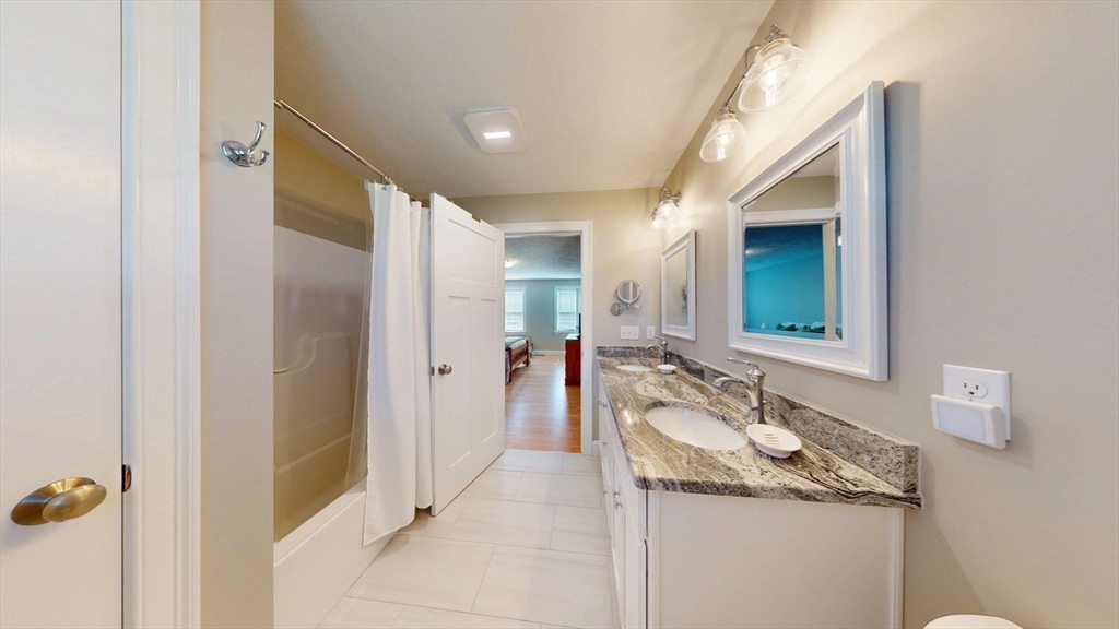 287 Wareham Street Middleboro, MA 02346 - Photo 15 of 28 a bathroom with a granite countertop sink and a mirror