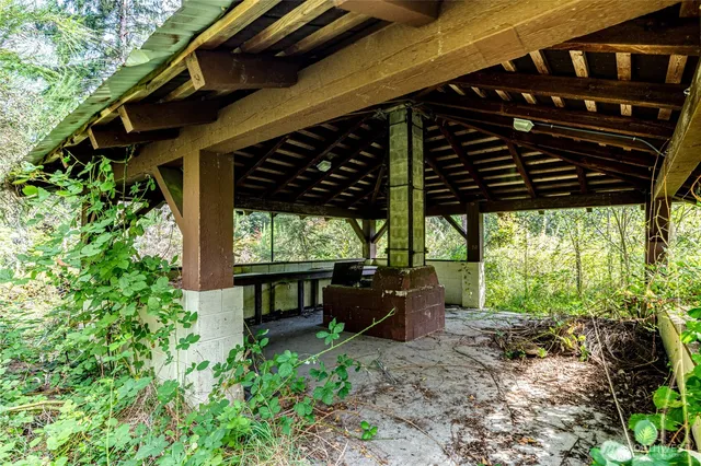 a view of a porch with furniture and a yard