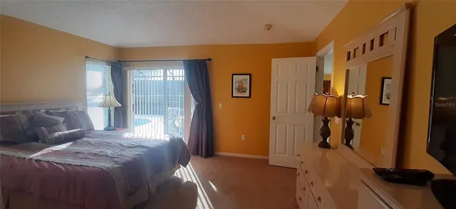 a bedroom with a bed and a mirror