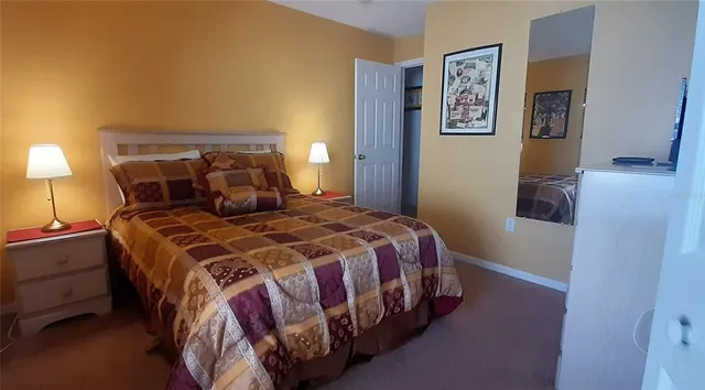 a bedroom with a bed and a lamp