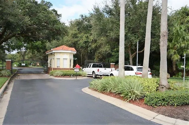 a front view of a house with a yard and fountain