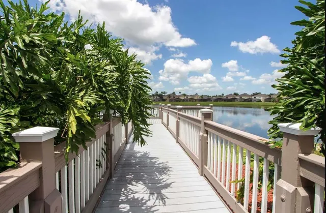 a living room with furniture kitchen view and a flat screen tv
