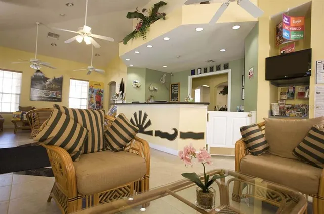 a view of a patio with a table and chairs under an umbrella with a small yard