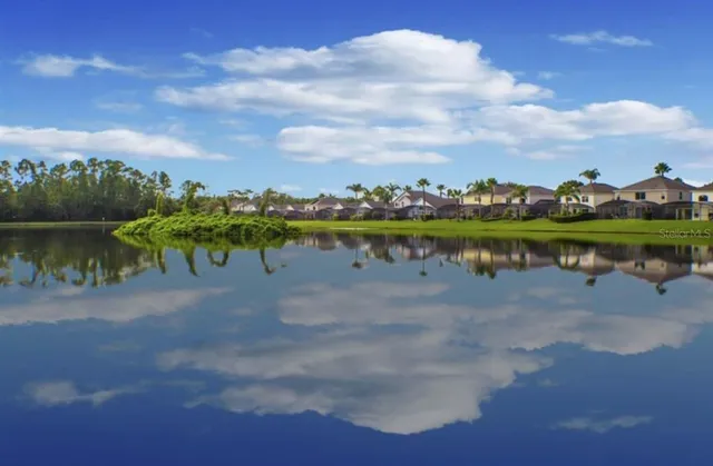 a view of a lake with houses in the back