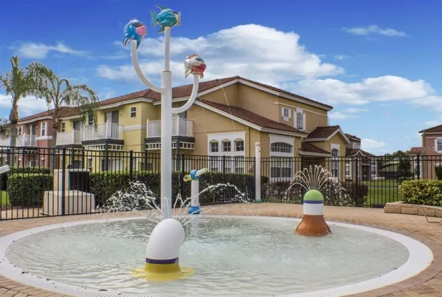 a view of a lake with a bench and trees around