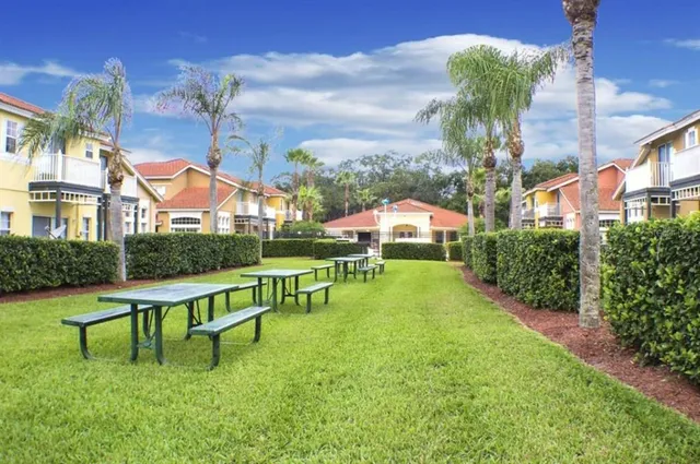 a view of a backyard with large trees