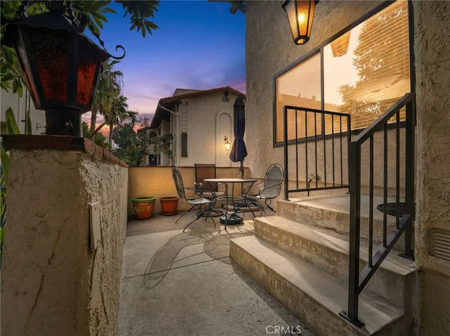 a view of a patio with table and chairs with wooden floor and fence