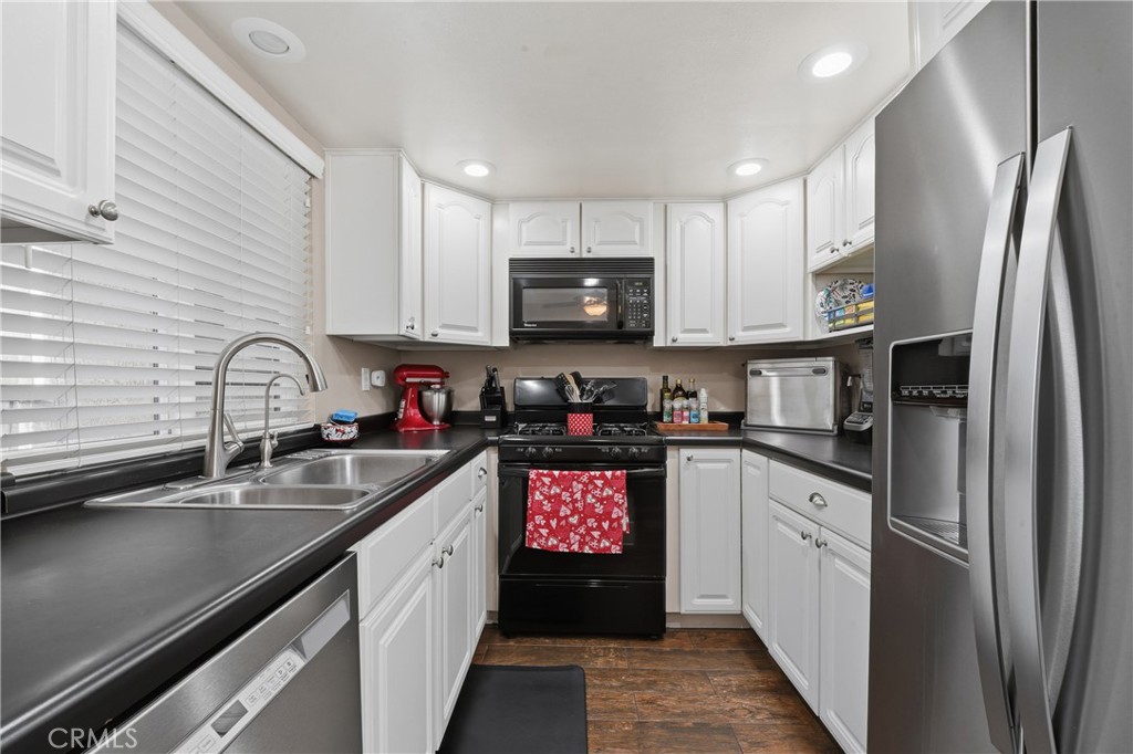 400 South Flower, Unit 99 Orange, CA 92868 - Photo 5 of 14 a kitchen with stainless steel appliances granite countertop a refrigerator a sink a stove and cabinets