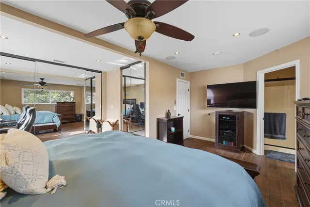 a bedroom with furniture and a flat screen tv