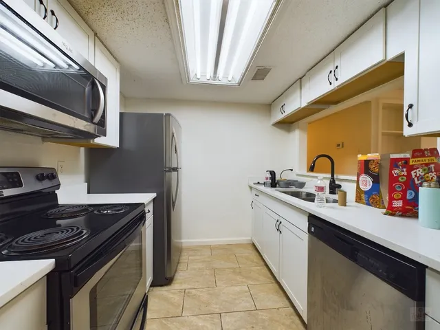 a kitchen with stainless steel appliances granite countertop a stove and a sink