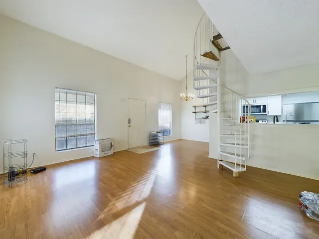 a view of empty room with wooden floor