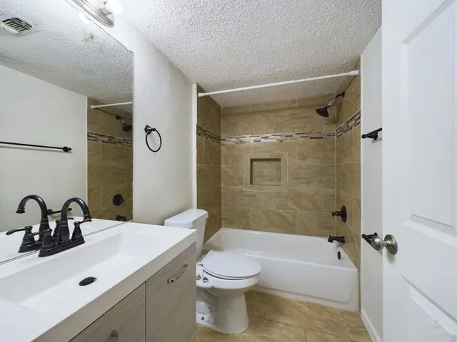 a bathroom with a sink toilet tub and shower