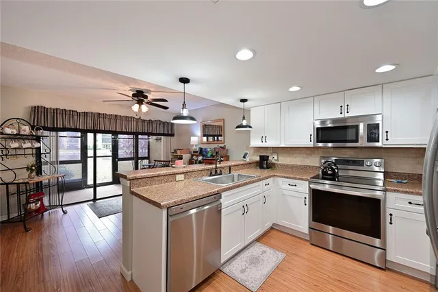 a kitchen with stainless steel appliances granite countertop a stove and cabinets