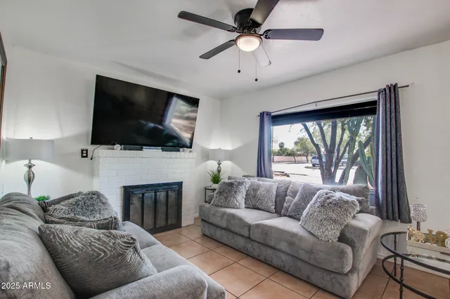 a living room with furniture a fireplace and a flat screen tv