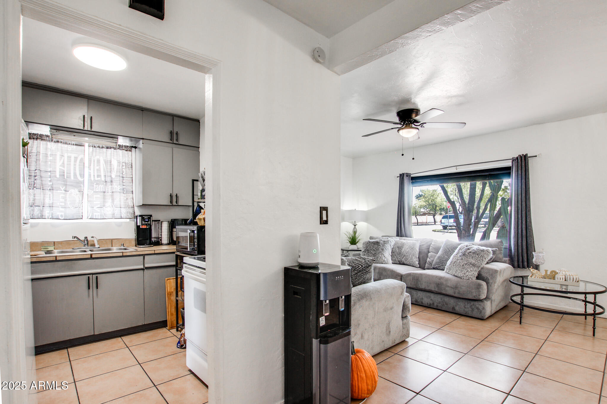 3273 East 27th Street Tucson, AZ 85713 - Photo 16 of 39 a kitchen with stainless steel appliances granite countertop a sink and a refrigerator