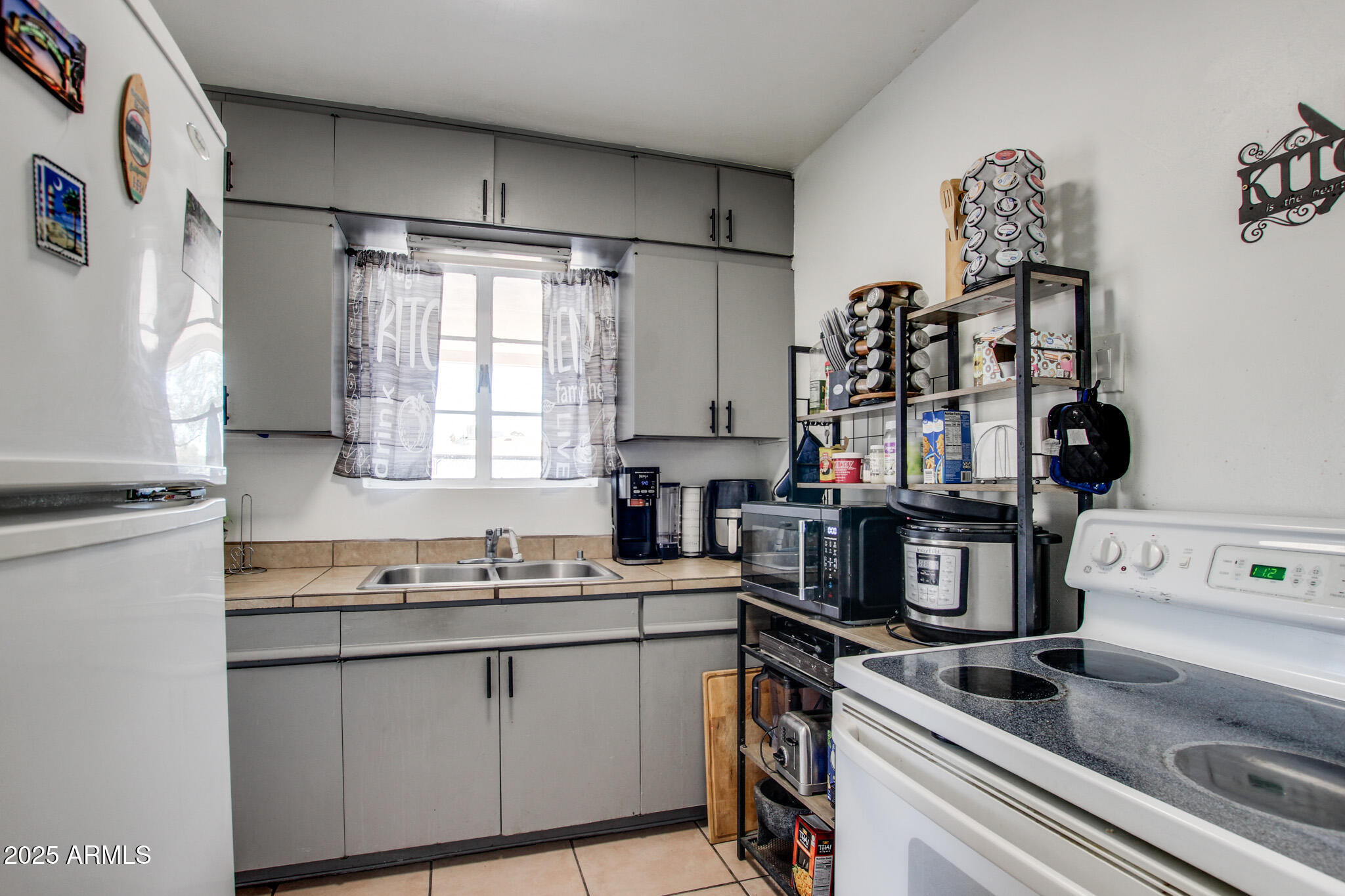 3273 East 27th Street Tucson, AZ 85713 - Photo 17 of 39 a kitchen with a sink appliances and cabinets