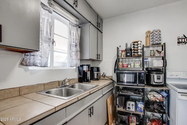 a kitchen with stainless steel appliances a sink and a window