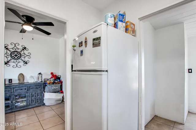 a white refrigerator freezer sitting inside of a kitchen