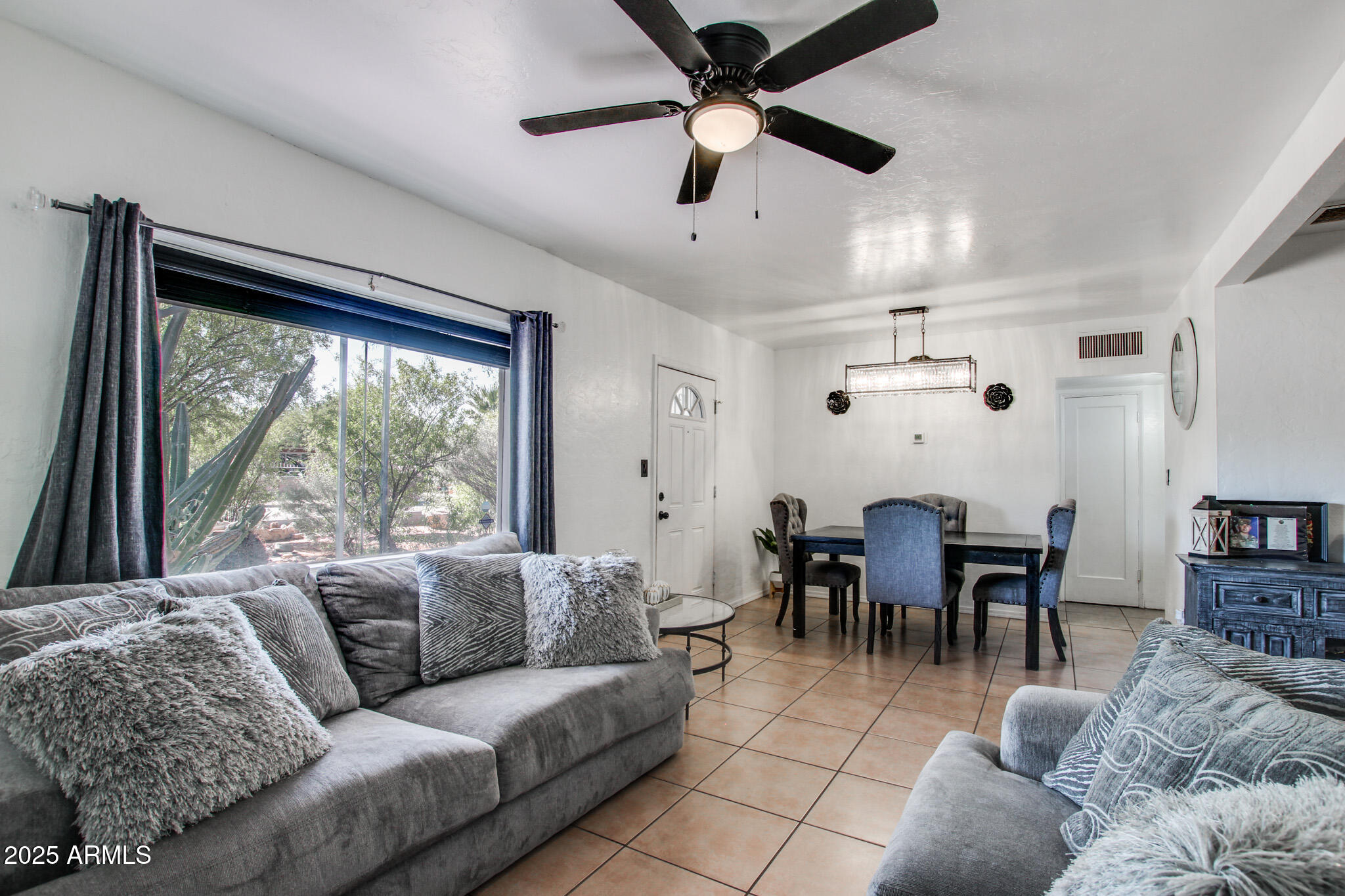 3273 East 27th Street Tucson, AZ 85713 - Photo 2 of 39 a living room with furniture and a large window
