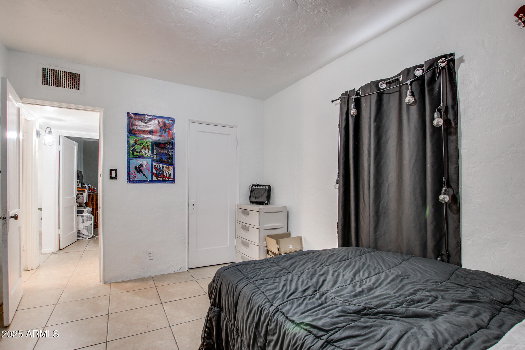 3273 East 27th Street Tucson, AZ 85713 - Photo 21 of 39 a bedroom with a bed and cabinets