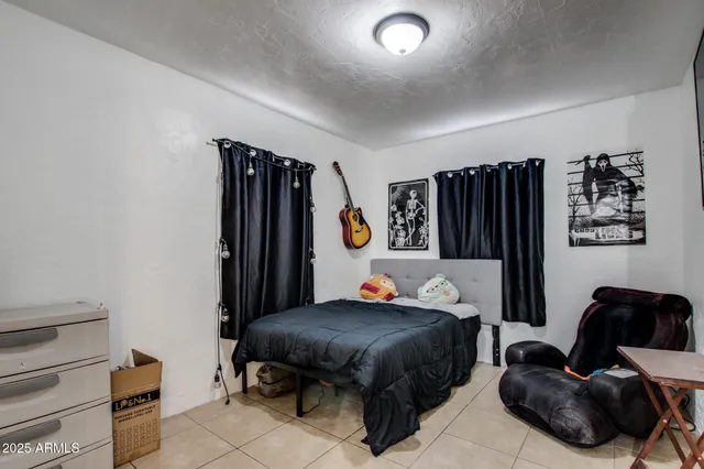 a bedroom with a bed and dresser