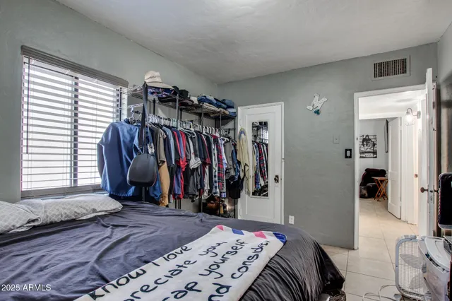 a bed room with a bed and a window