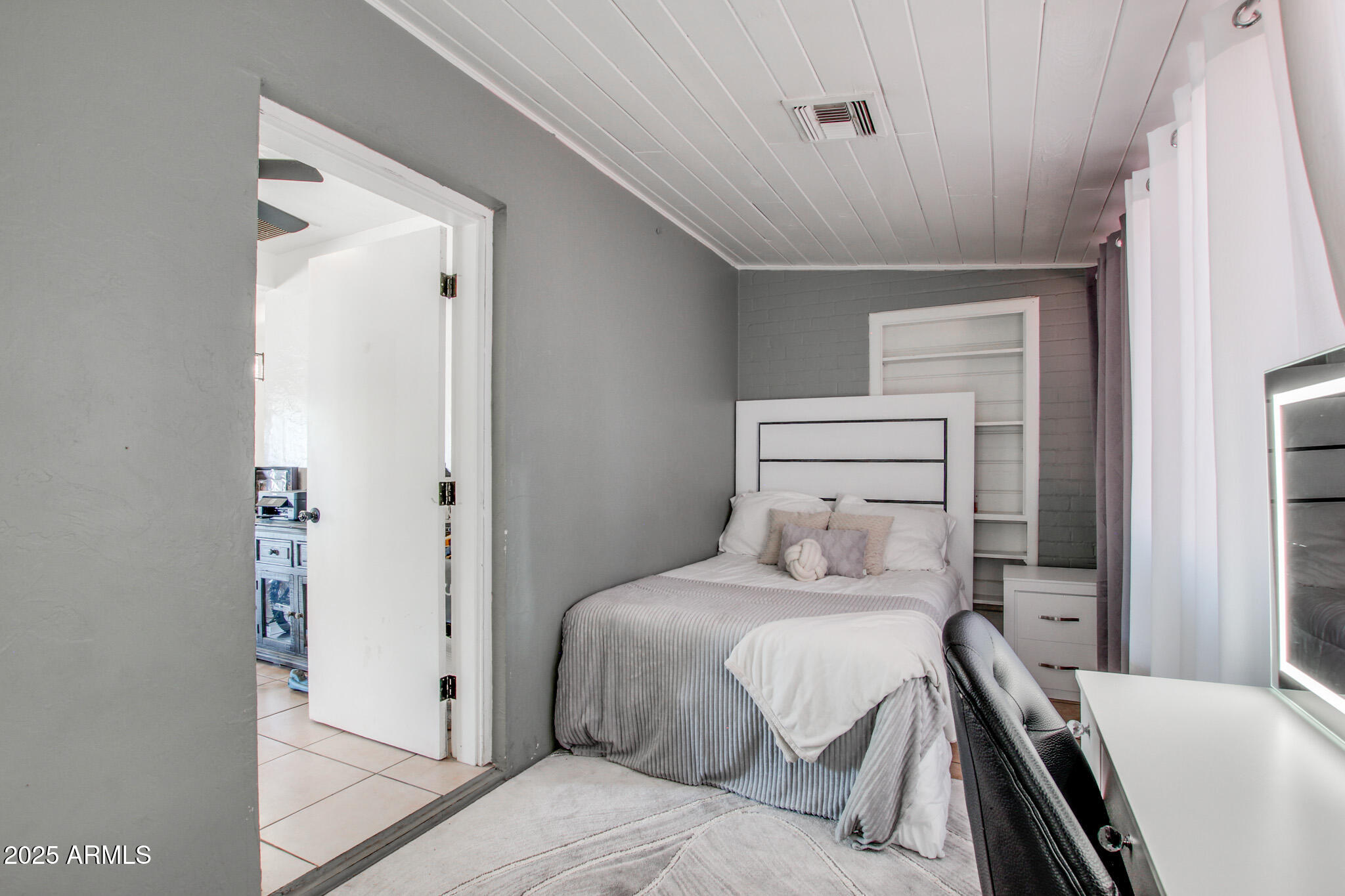 3273 East 27th Street Tucson, AZ 85713 - Photo 26 of 39 a bedroom with a bed and a walk in closet