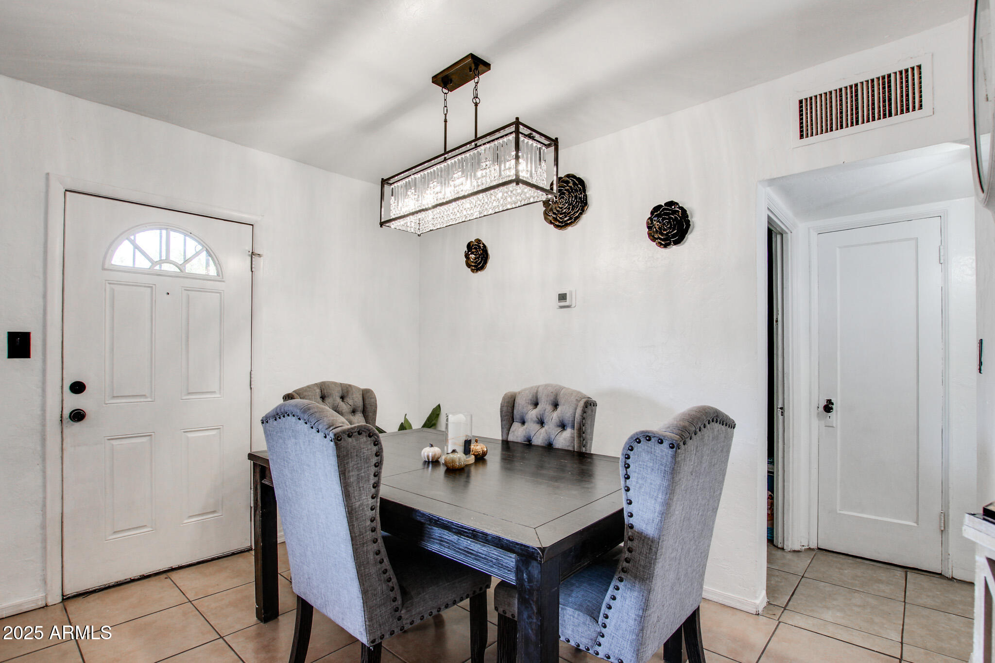 3273 East 27th Street Tucson, AZ 85713 - Photo 3 of 39 a view of a dining room with furniture and chandelier