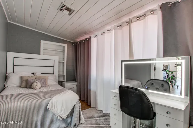 a bedroom with a bed and a chair