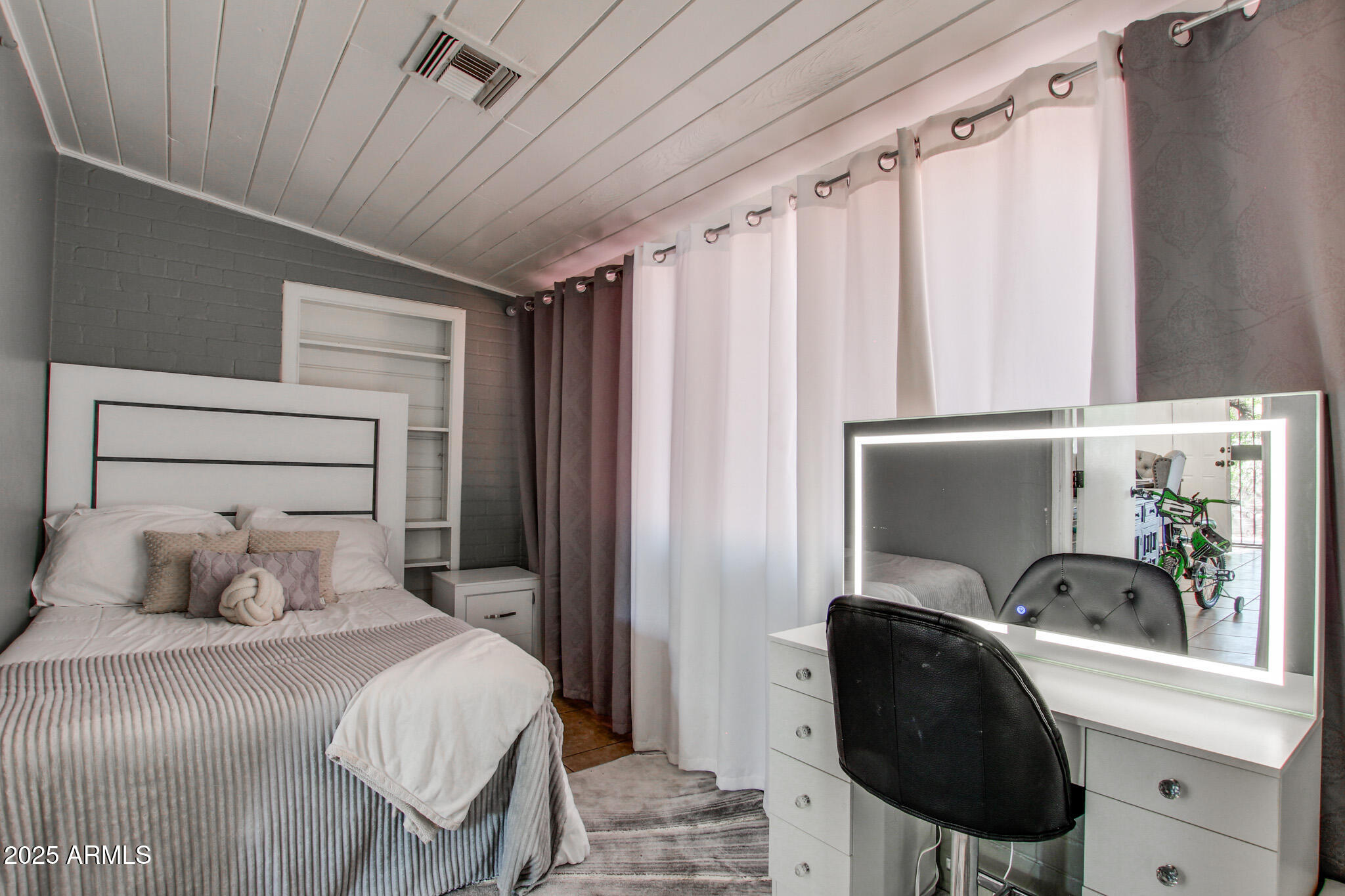 3273 East 27th Street Tucson, AZ 85713 - Photo 4 of 39 a bedroom with a bed and a chair