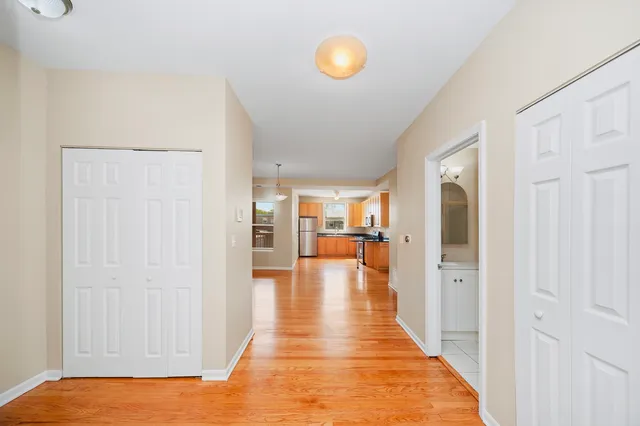 a view of walk in closet with wooden floor