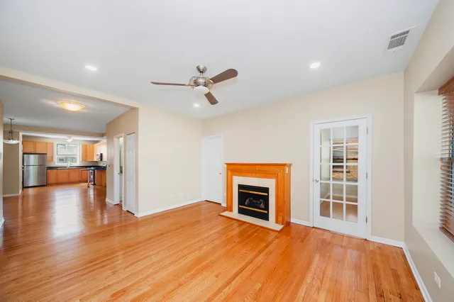 a view of an empty room with a window and fireplace