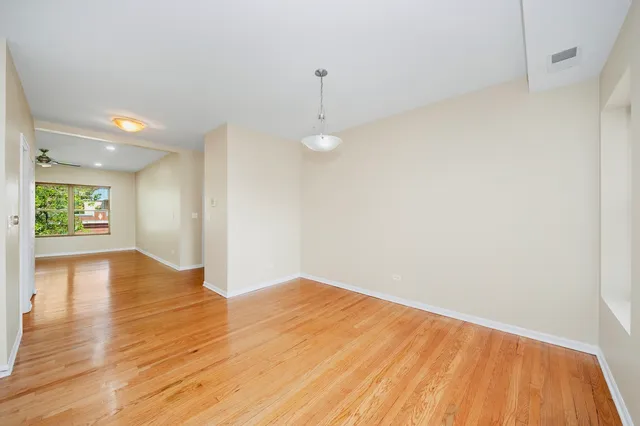 a view of an empty room with a fireplace and a window