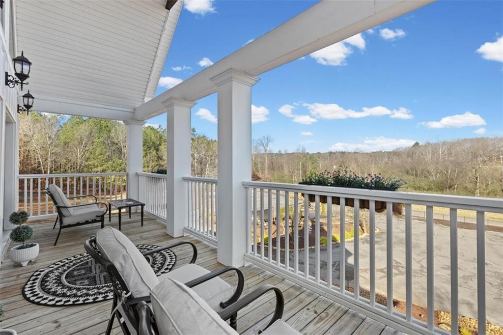 250 Crowe Springs Road Northwest Cartersville, GA 30121 - Photo 28 of 81 a view of a balcony with chairs and wooden floor