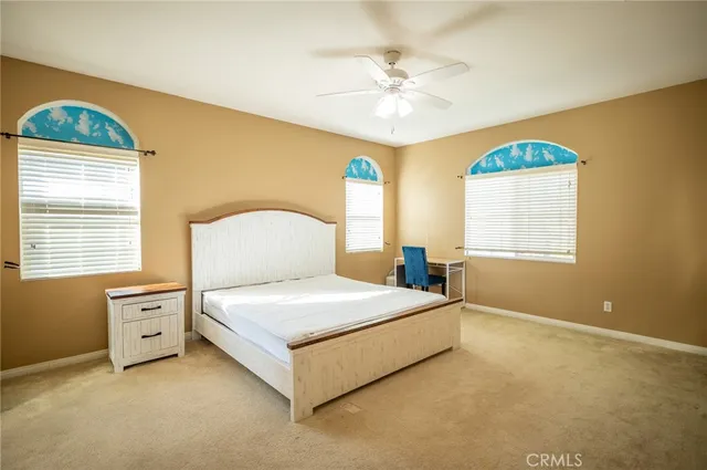 a bedroom with a bed dresser and a window