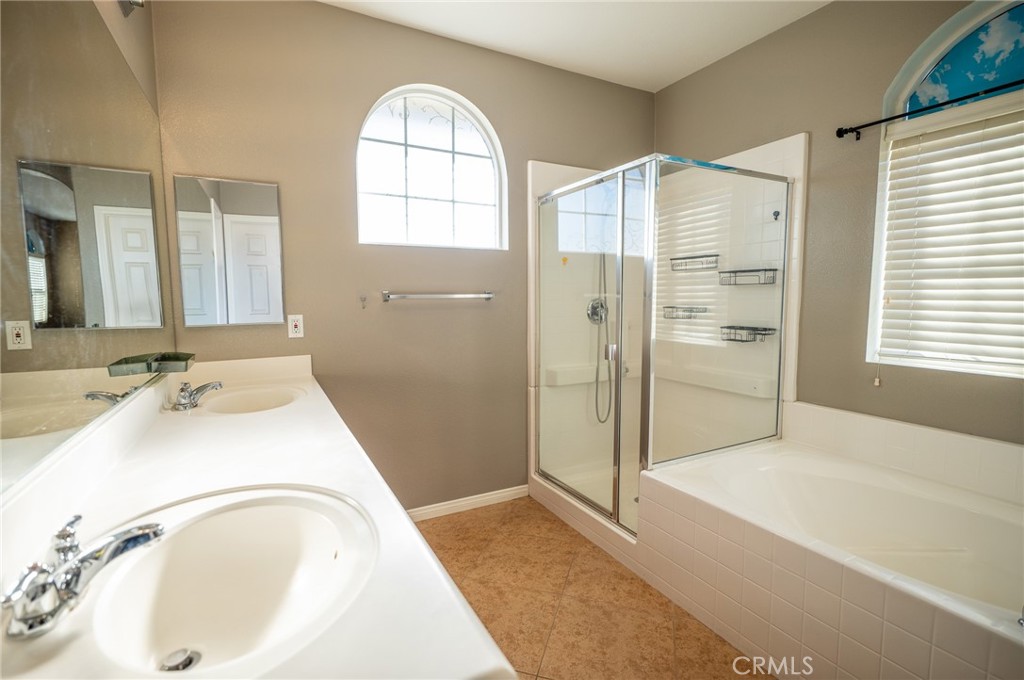13208 Firestone Drive Rancho Cucamonga, CA 91739 - Photo 15 of 21 a spacious bathroom with a tub sink and mirror
