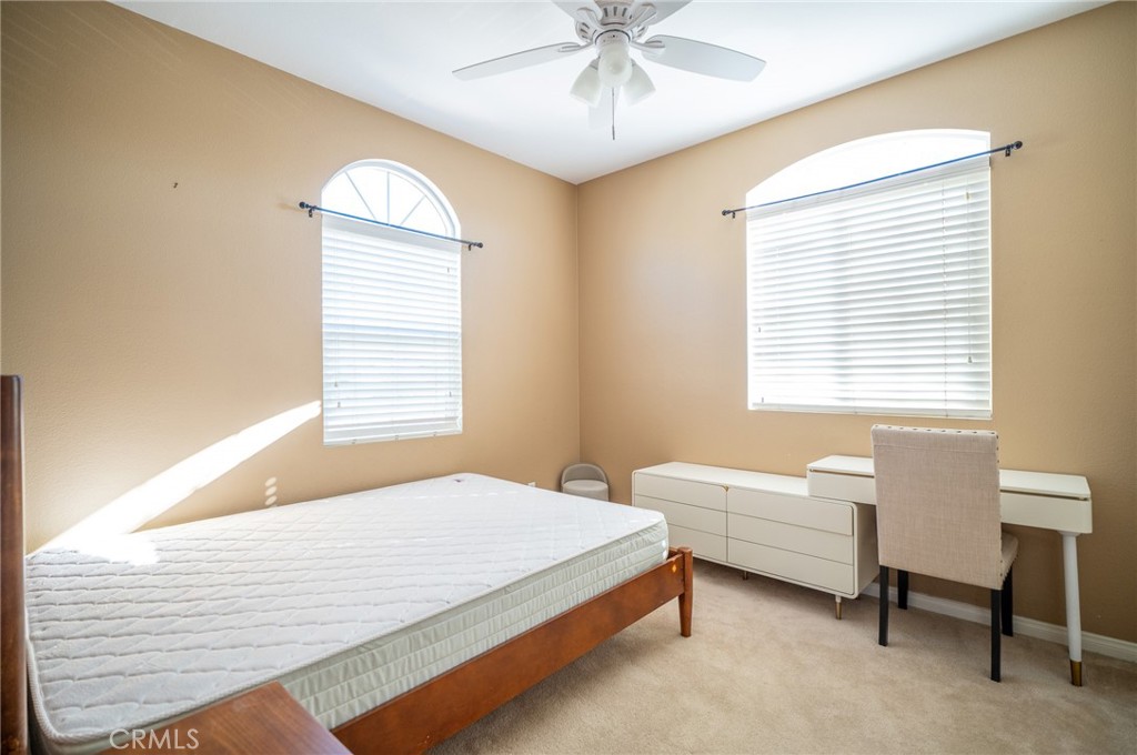 13208 Firestone Drive Rancho Cucamonga, CA 91739 - Photo 19 of 21 a bedroom with a bed and a chandelier